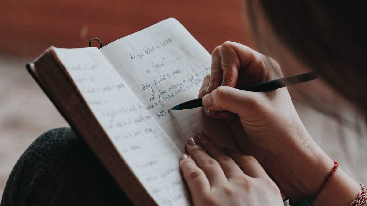 A person writing in a journal
